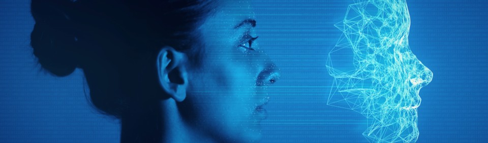 Profile of a woman facing a digital wireframe face made of blue geometric lines, symbolizing human–technology interaction.
